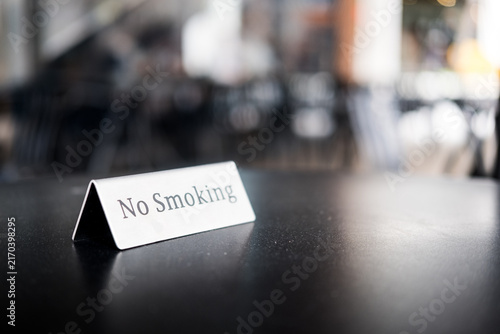 No smoking sign stainless steel, standing on a table