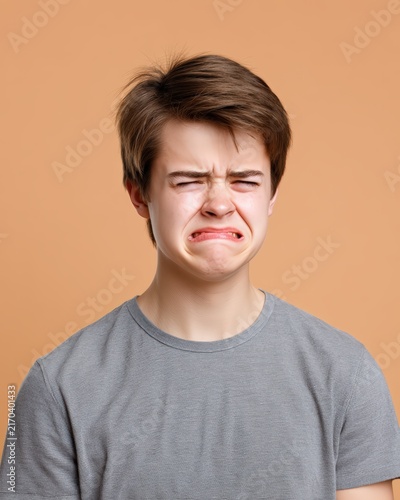 Sad teenage boy crying with an emotional facial expression