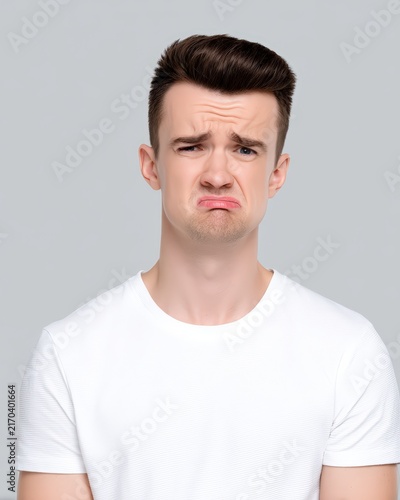 Young man making a sad crying facial expression