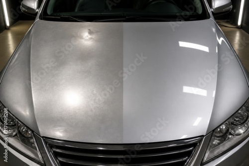 Car hood half polished and half oxidized in detailing garage