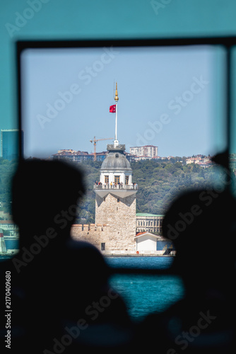 View of the Maiden's Tower from the window of a ferry or ship. Maiden's Tower (kız kulesi) in the middle of the Bosphorus. Popular tourist destination.