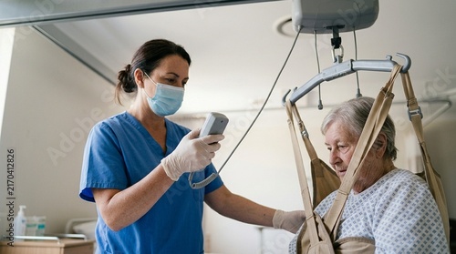 Nurse operating a bariatric patient lift to safely transfer a patient during a procedure