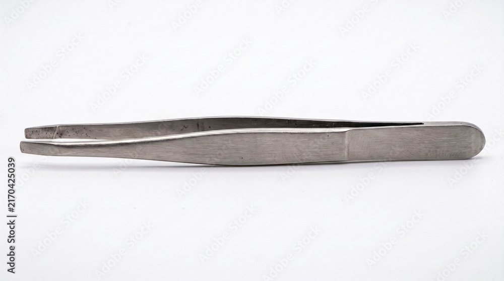 Fototapeta premium close-up view of a single stainless steel pair of tweezers on a white background