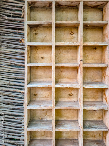 Rustic wooden shelves with woven twig wall, evoking traditional Ukrainian craftsmanship
