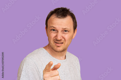 фотографія Man pointing finger accusingly with a skeptical expression on his face