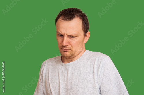 Принти на полотні Man with a disgusted expression looking down with furrowed brows