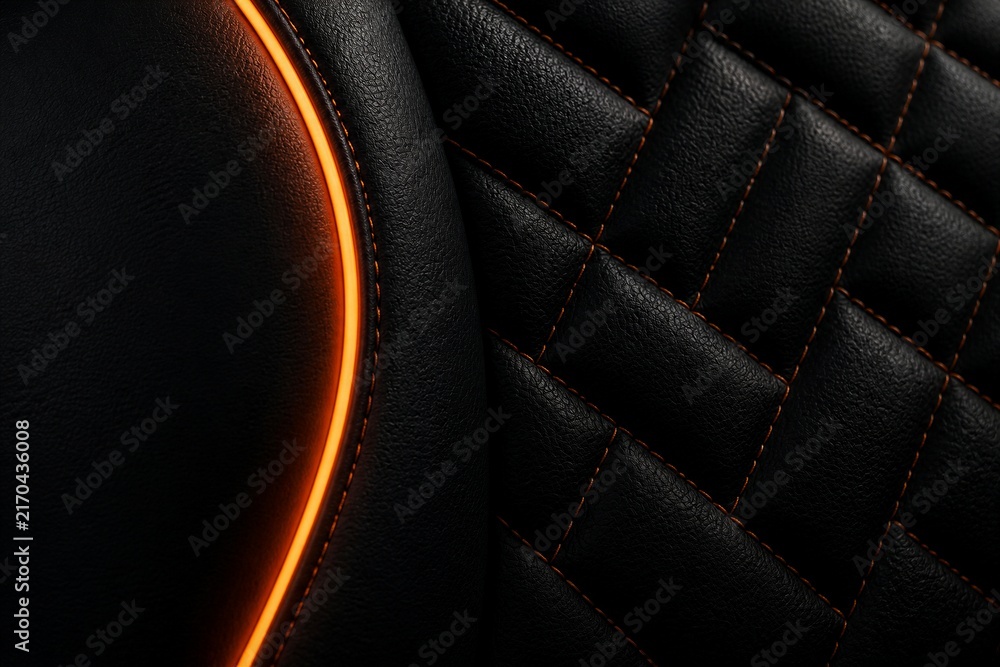 Fototapeta premium Leather seat detail with illuminated orange trim in car interior