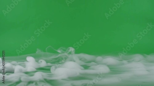 Dense white smoke or dry ice fog rolling, green screen video 4K. vapor gas steam cloud mist