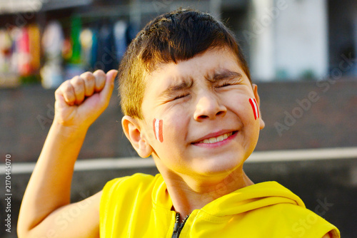 Foto Excited little peruvian with national flag painted on cheeks.