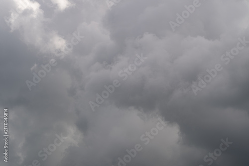 Thick thunderheads gather with heavy mood, deep grays and concealed light imply imminent storm and intensity strong visual for climate stories and dramatic editorials