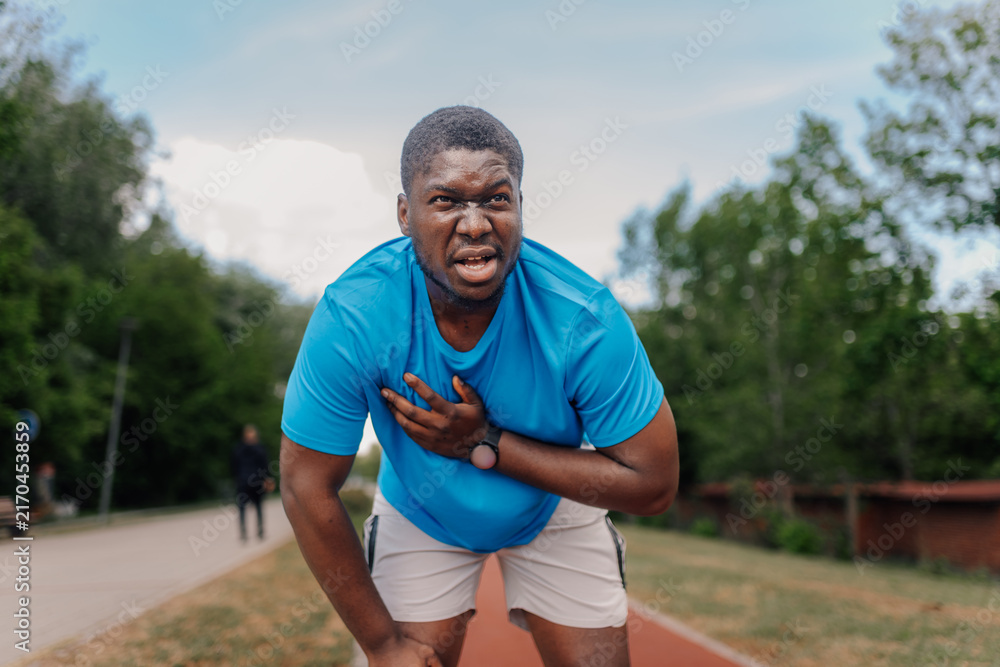 Fototapeta premium Man having chest pain during outdoor running workout