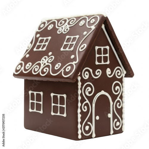 A cute brown gingerbread house cookie decorated with white icing for the christmas holiday season celebration