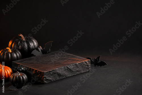 Black stone product podium with pumpkins and copy space