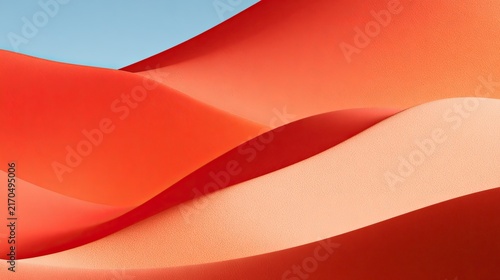 Abstract flowing waves of orange and peach hues under a clear sky