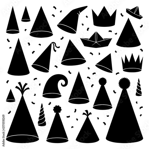 Various black party hats, crowns, and paper boats with confetti scattered on a white background, for festive projects