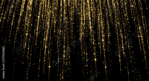 Falling golden glitter particles on black background luxury sparkling light streaks festive celebration overlay with shiny gold bokeh dust