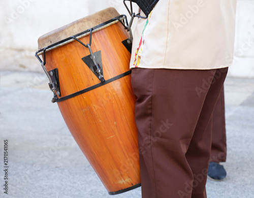 Man playing the drum and wearing one of the traditional costume from Chile