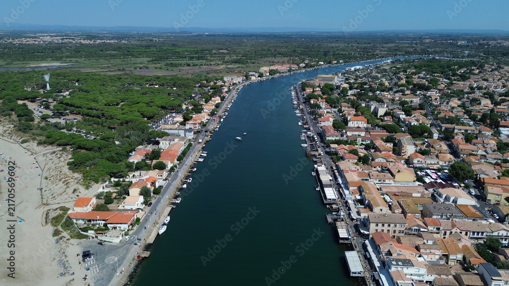Obraz premium Aerial view of the Herault river mouth flowing into the Mediterranean Sea at Le Grau d'Agde, France