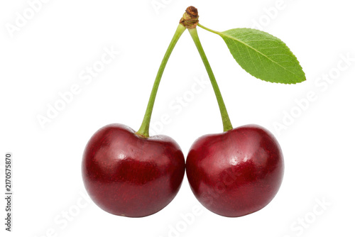 Obraz na plátne Two fresh ripe red cherries with vibrant green stems and a single leaf, isolated