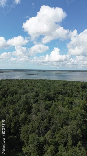 Clouds over sea and forrest in insta format