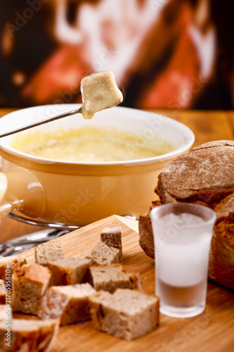 Cheese fondue with bread and schnapps