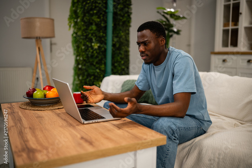 Canvastavla Young man feeling frustration working with laptop at home