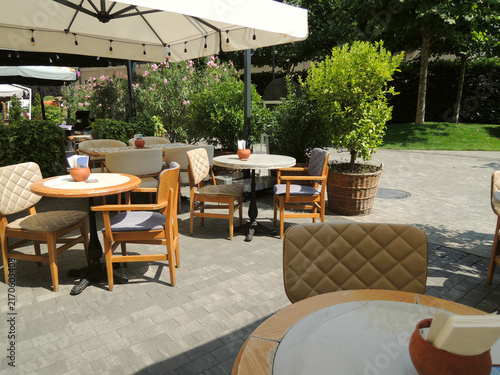 Outdoor Restaurant Patio with Tables and Chairs on Sunny Day
