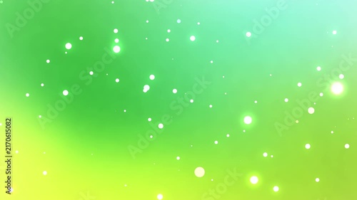Green and yellowish-green glowing particles rising diagonally, dreamy abstract background, seamless loop.