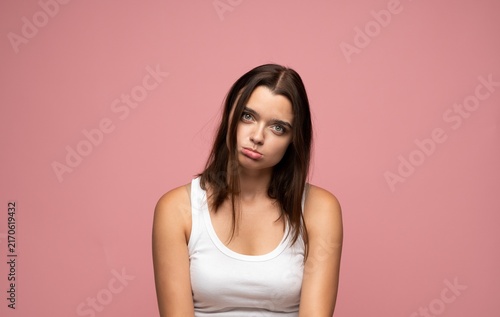 Fotografie Young woman feeling unmotivated and sluggish, expressing disinterest and wearine