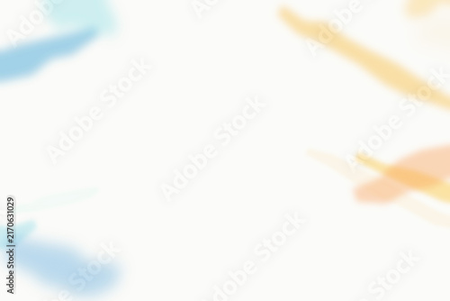 Soft abstract watercolor brush strokes in light blue and pale orange colors on a clean white background, artistic minimalist composition