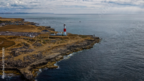 Aerial view of Portland Bill Lighthouse standing on the rocky coastline of the Isle of Portland with the English Channel in the background, Portland, Dorset, United Kingdom.