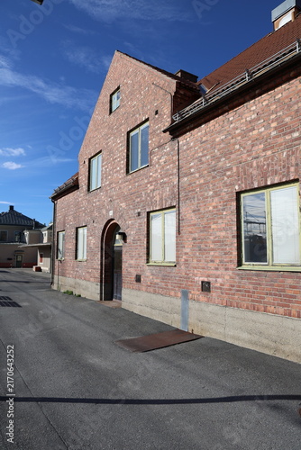 A red brick building at Östersund central station under a clear blue sky.