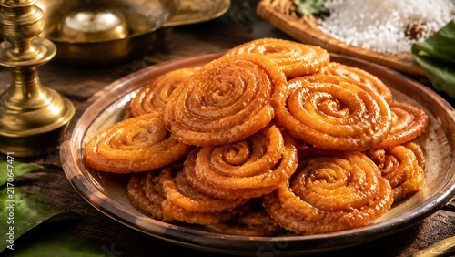 Authentic Sri Lankan Pani Walalu Traditional Spiral Sweet With Glossy Treacle Syrup Coating Served in Rustic Plate for New Year Celebration and Cultural Food Marketing