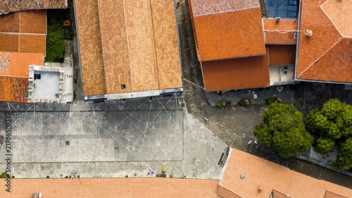 Aerial view of Motovun featuring historic stone buildings with terracotta rooftops surrounding a central paved square in Motovun, Istria County, Croatia.