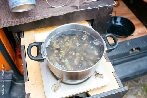 Preparing food on portable camping stove during van life trip