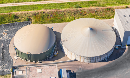 Aerial view of anaerobic digestion tanks at a biogas plant with processing buildings and technical infrastructure for renewable energy in Le Pouzin, Auvergne-Rhone-Alpes, France.