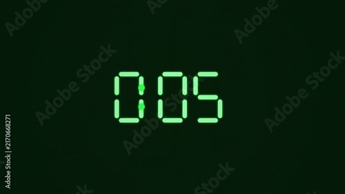 Digital countdown timer green led numbers counting down on dark background motion graphic