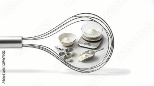 Baking ingredients and kitchen scale framed inside whisk wire loop