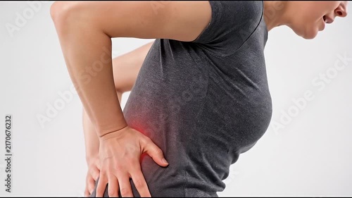 Pregnant woman lower back pain and lumbar ache with hands holding waist, abdomen discomfort during pregnancy, showing physical strain and wellness care concept against light background