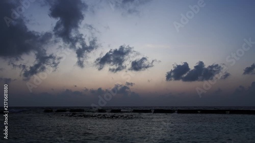 Sunset sea timelapse with dramatic clouds over tropical horizon