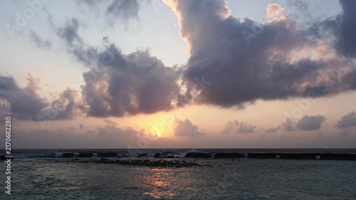 Sunrise timelapse over ocean with clouds
