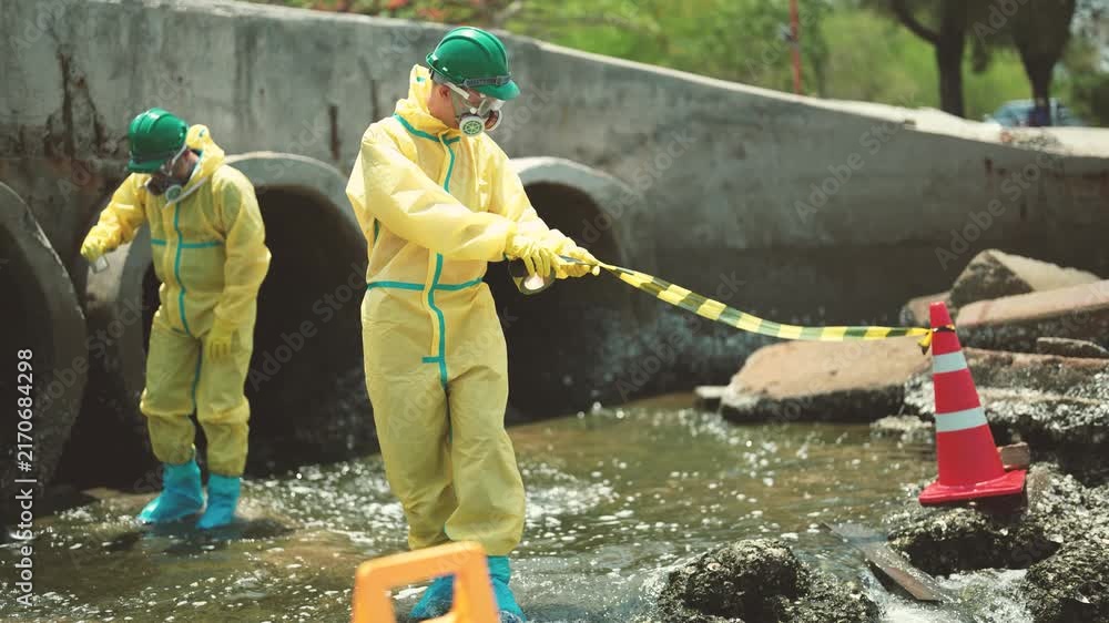 Sample Waste Sample Environmental workers standing in secured area and collecting ...