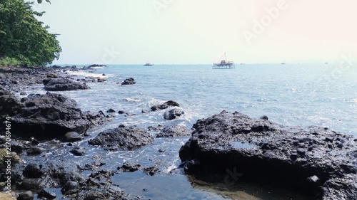 Rocky beach meets clear blue ocean creating a beautiful tropical coastal landscape