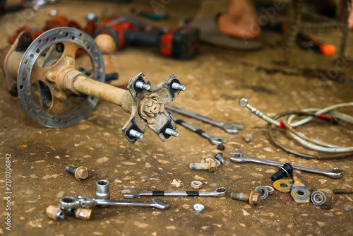 Bild auf Leinwand Automotive repair tool workshop with disassembled axle, brake rotor, wrench, soc