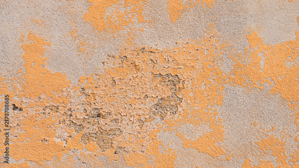 Fototapeta premium A concrete wall with faded yellow paint