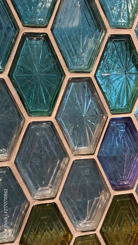 Colorful hexagonal glass tiles create geometric pattern for vibrant interior design background
