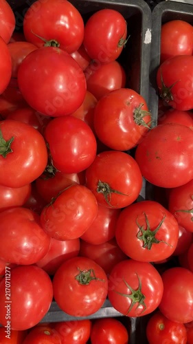 Fresh red tomatoes stacked closely, showcasing vibrant color and texture, suitable as a background