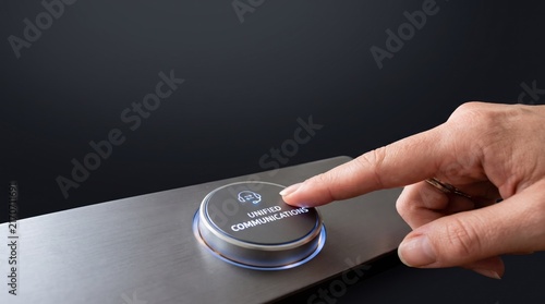 Hand pressing round start and stop control button on sleek metallic interface panel. Modern touch interaction for electronic device operation.