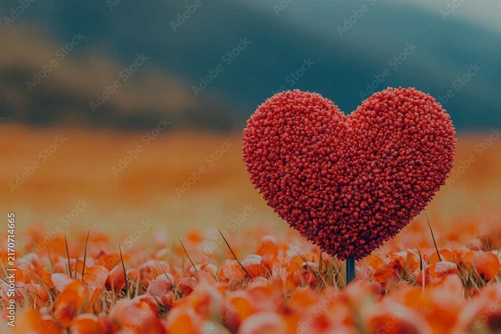 Fototapeta premium Heart shaped sculpture in red textured design standing in orange flower field representing romance emotion holiday love celebration background
