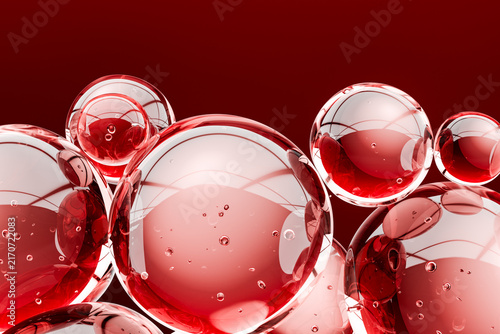 Abstract 3D composition of glossy transparent spheres with bubbles and reflections on a rich red background. Modern artistic texture with a dynamic, luxurious and futuristic visual aesthetic.
